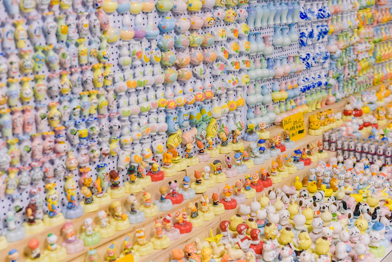Vibrant array of ceramic figurines, neatly arranged on display shelves, showcasing diverse handcrafted designs.